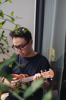 a man playing a guitar using online tuner video