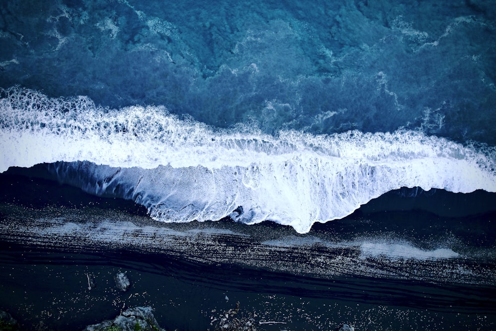 a wave crashing on a rocky shore