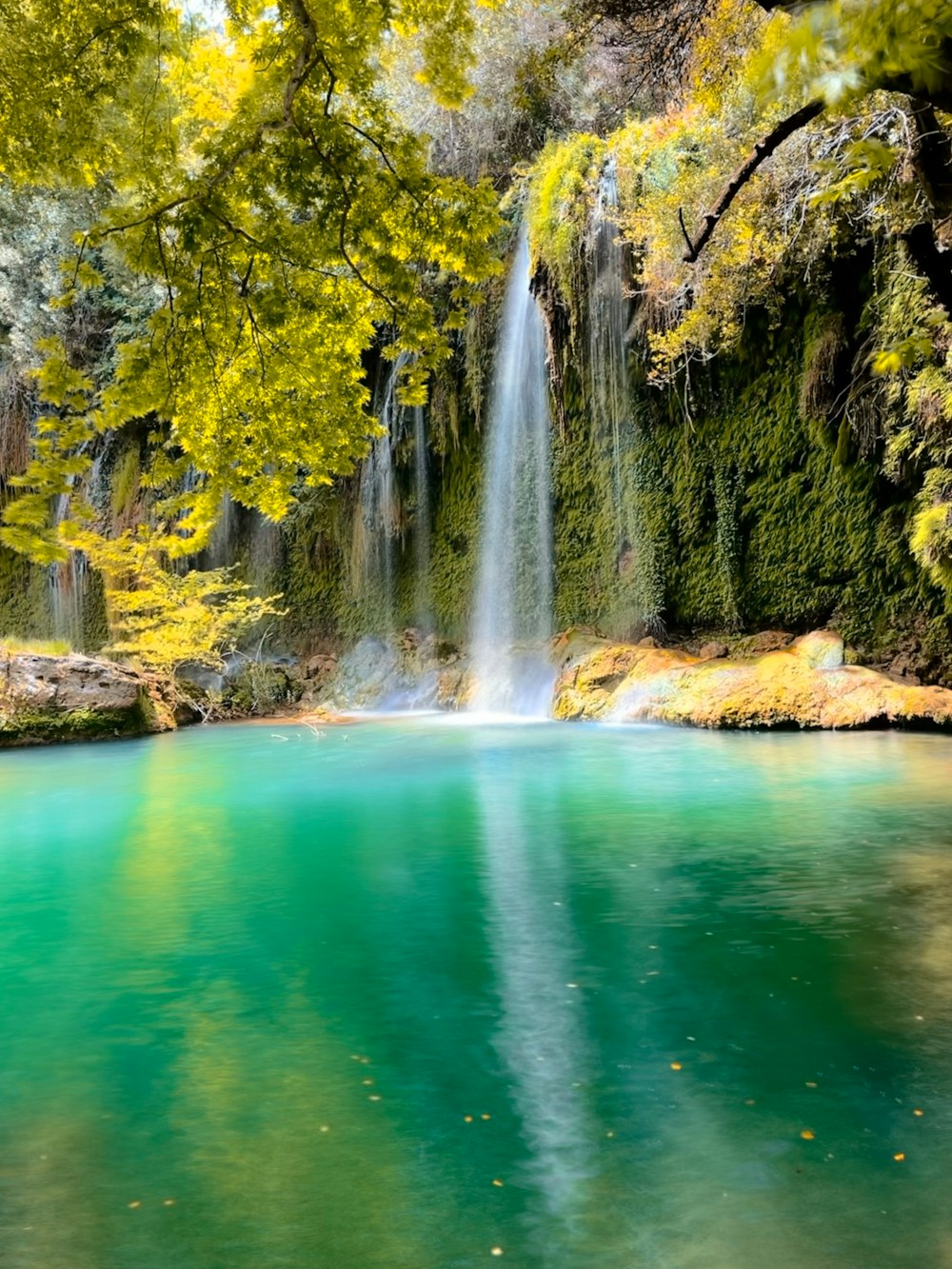 a waterfall over a body of water