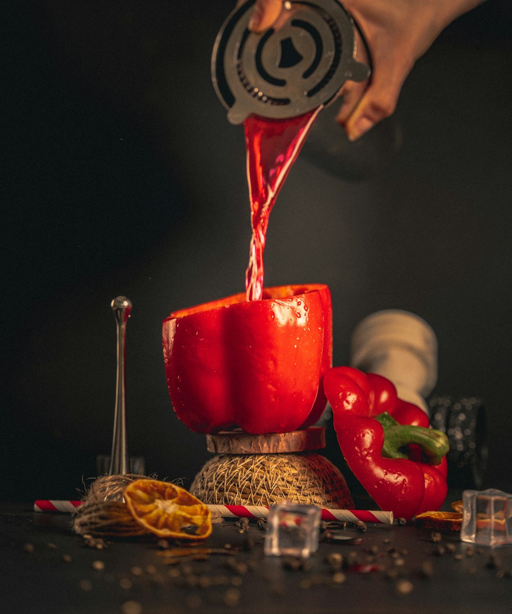 a person pouring liquid into a glass