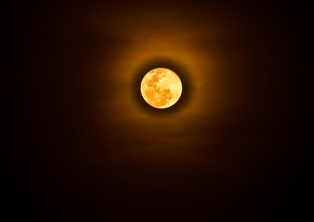 a full moon in a dark sky