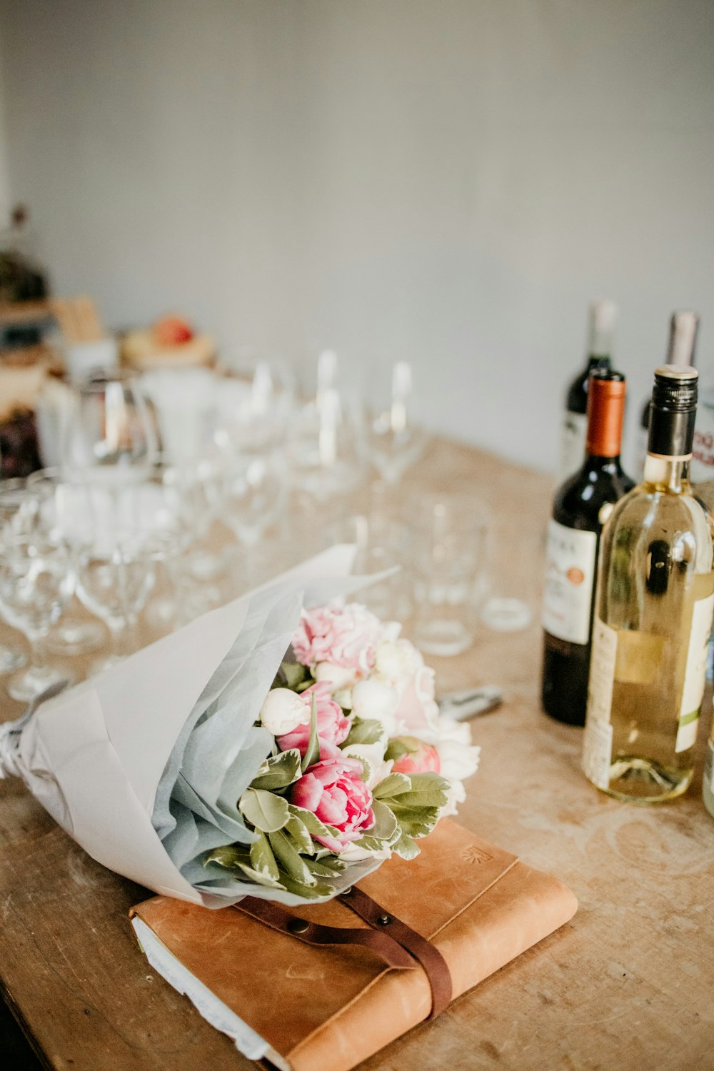 a table with wine bottles and glasses