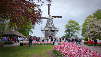 a crowd of people in front of a tall tower