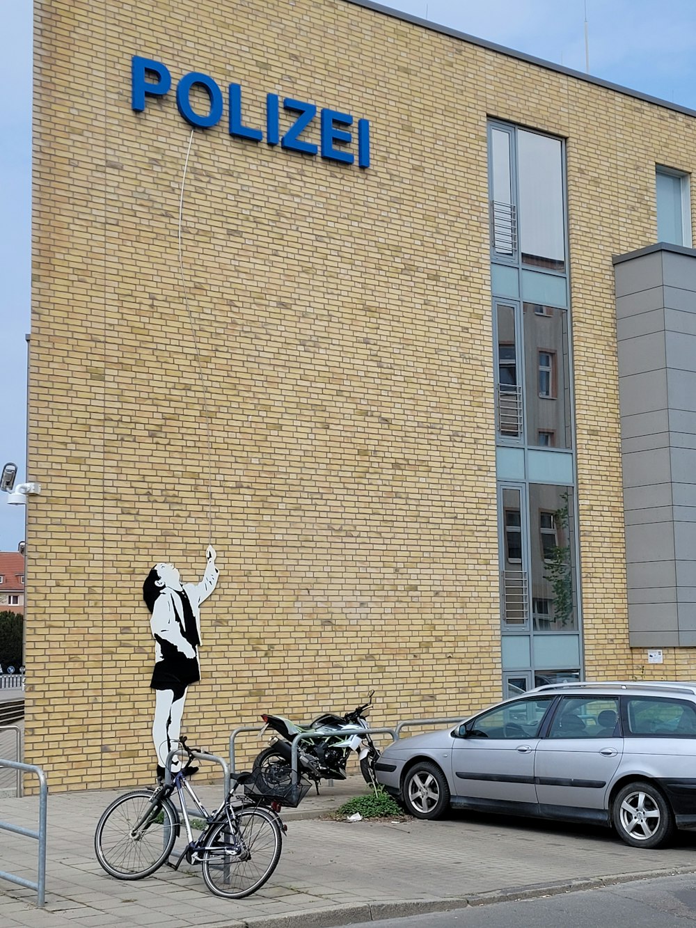 a person on a bicycle in front of a building