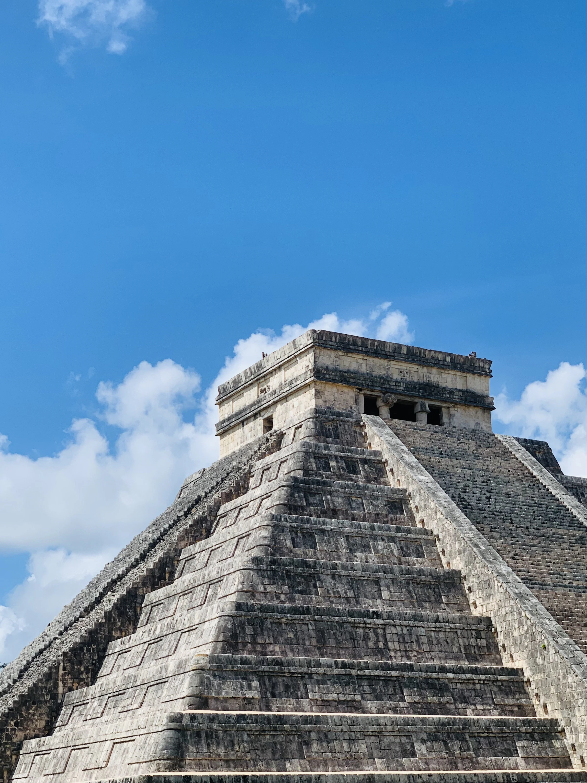 El Castillo pyramid at Chichen Itza under a bright blue sky