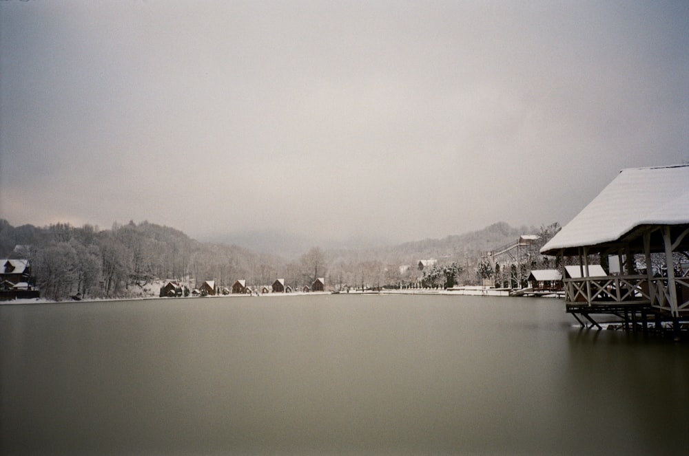 a body of water with buildings and trees around it