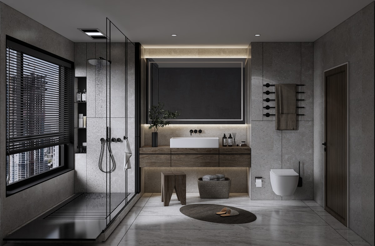 Modern hotel bathroom with a curbless glass walk in shower