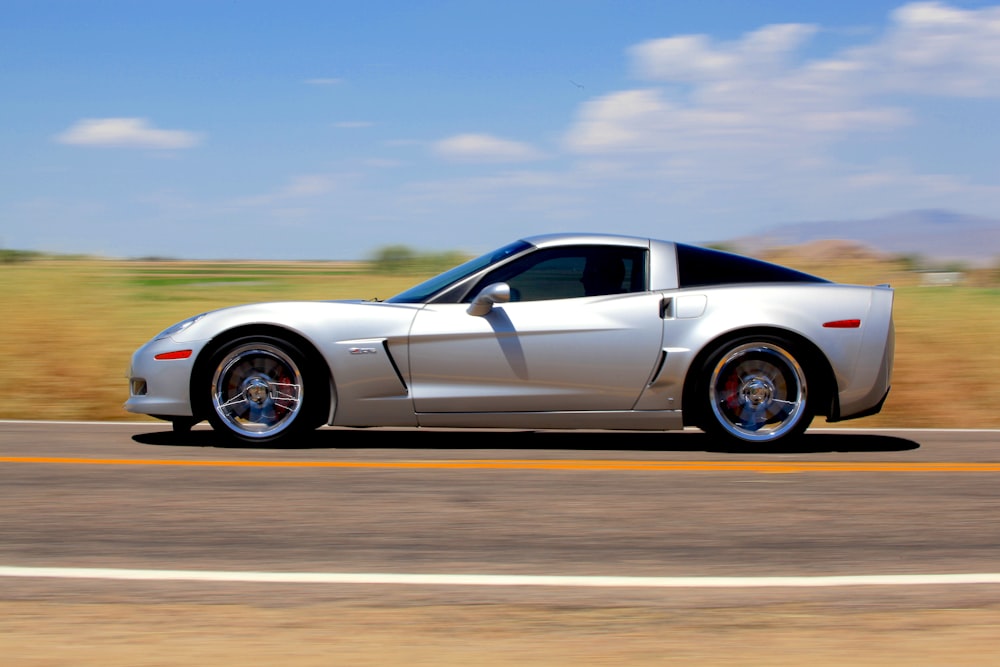 a white sports car on a road