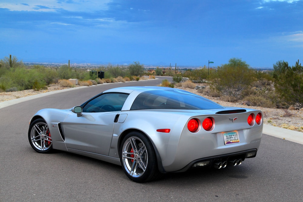 a white sports car on a road