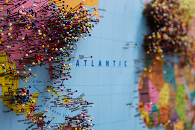 A map of Europe with colorful pins marking popular travel destinations.