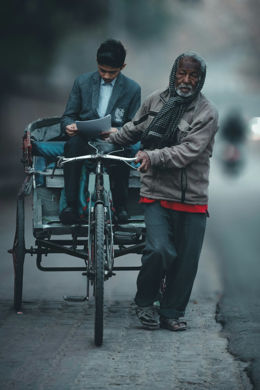 a man pushing a man on a bicycle
