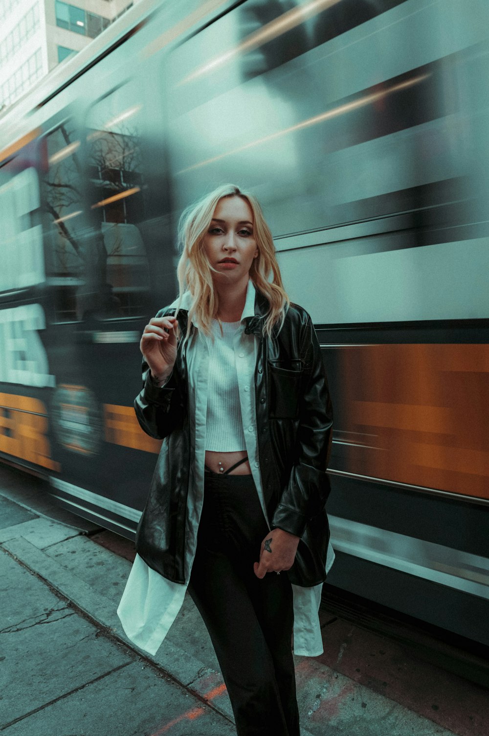a woman standing next to a train