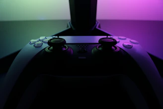 A colorful LEGO creation next to a modern gaming controller glowing with neon lights.