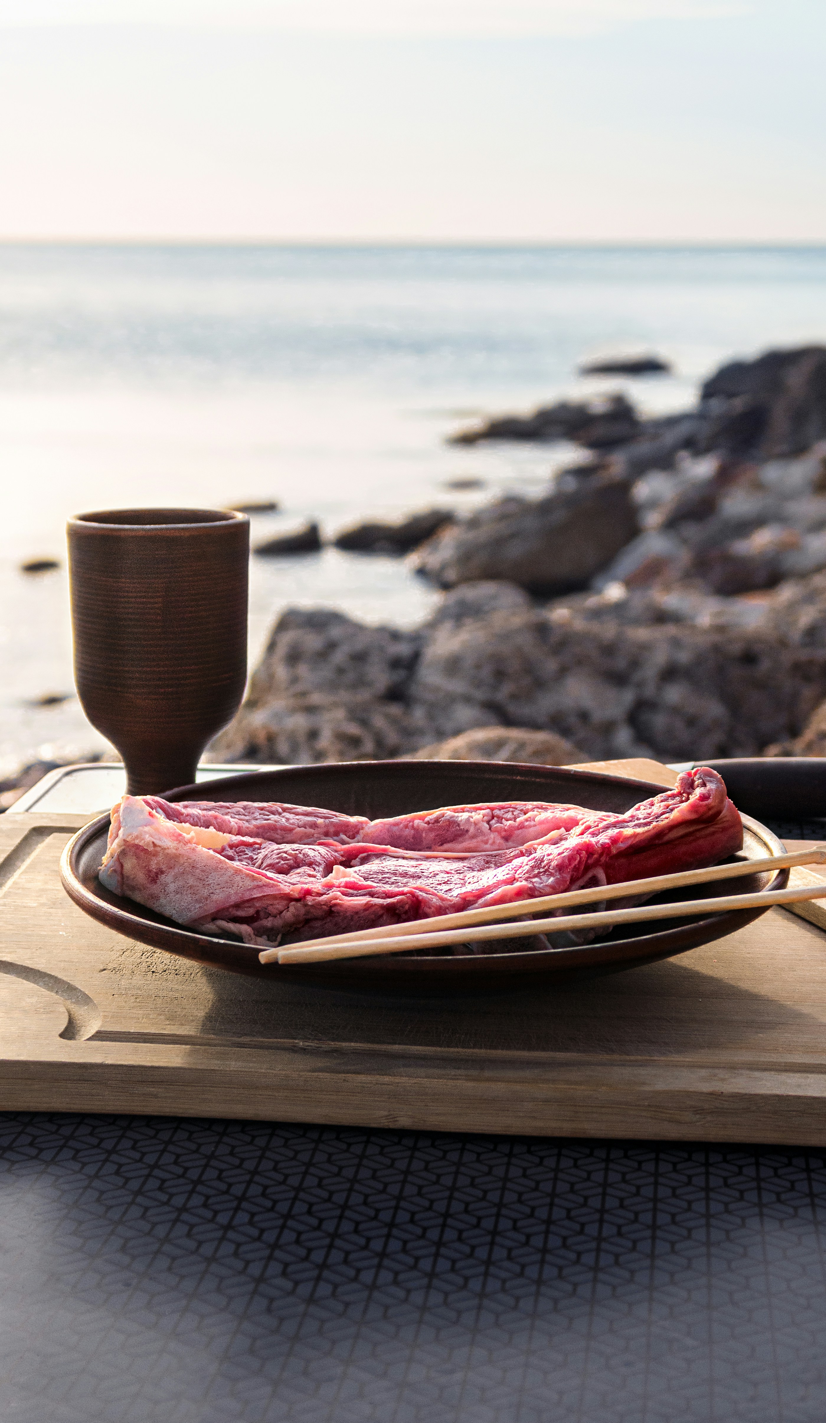 I photographed this frame in a particularly beautiful place, on the seashore. I really like how the sun spreads warm rays over a plate of food. And even if the food is not cooked yet, it fits perfectly into my idea of a comfortable vacation in nature. If you like my photos and want to support me, subscribe to my instagram. I will be very happy!