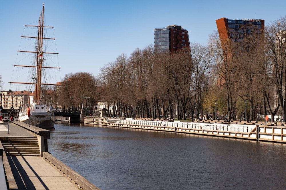 a body of water with a bridge and buildings in the background