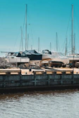 A panoramic shot of several boats docked, each sporting custom canvas covers by Nautishield.