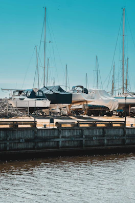 A panoramic shot of several boats docked, each sporting custom canvas covers by Nautishield.