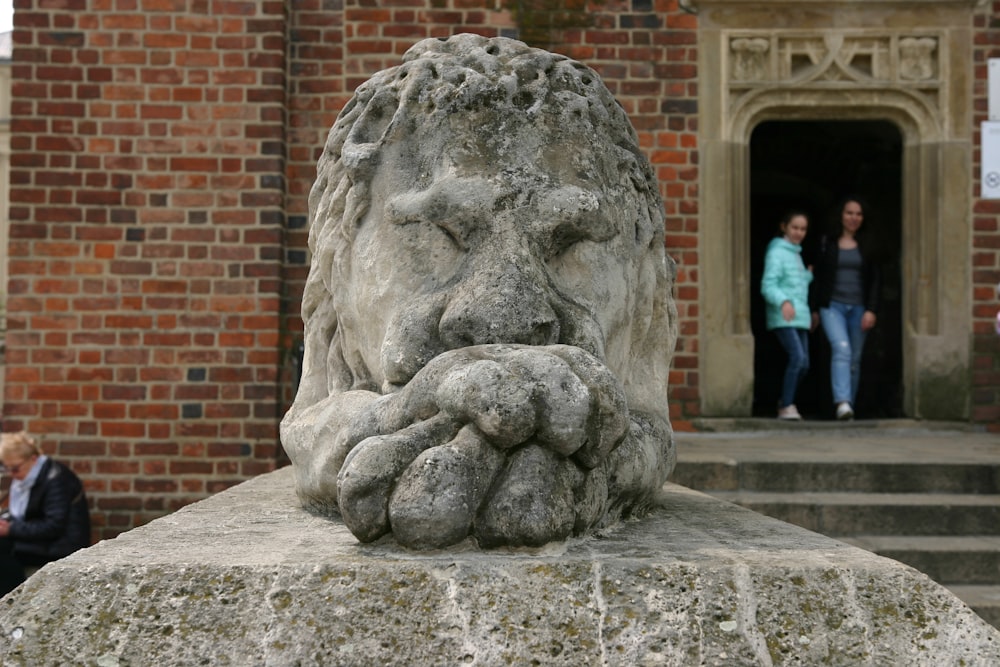 a stone statue of a person with a face on it