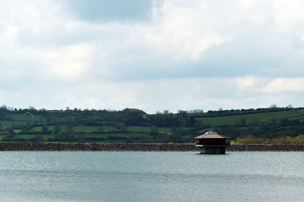 a body of water with a building in the distance