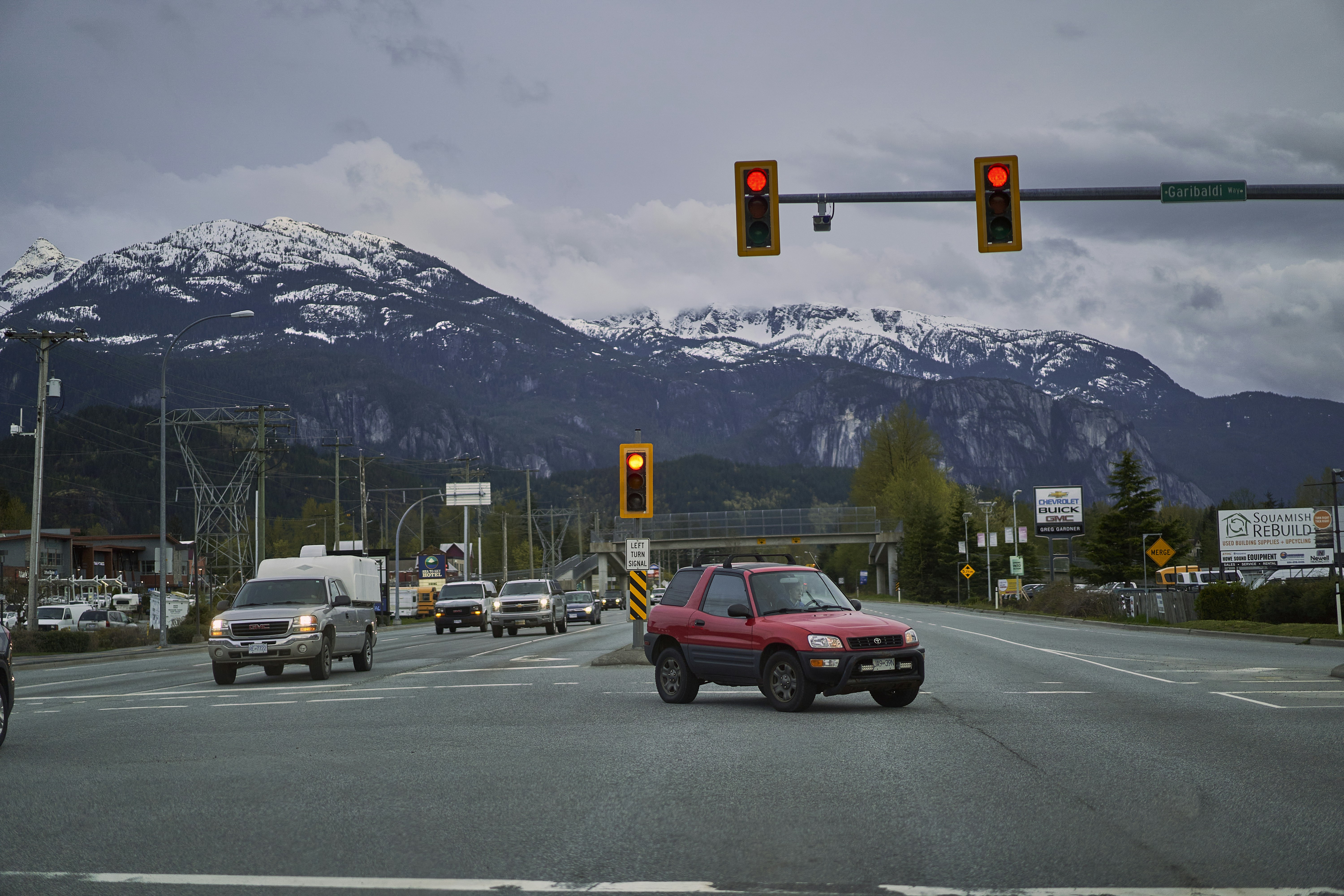 a red truck driving down the street