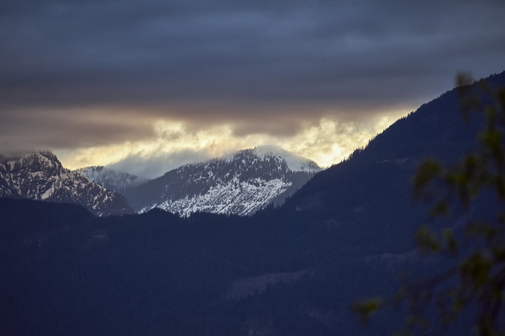 a mountain range with clouds