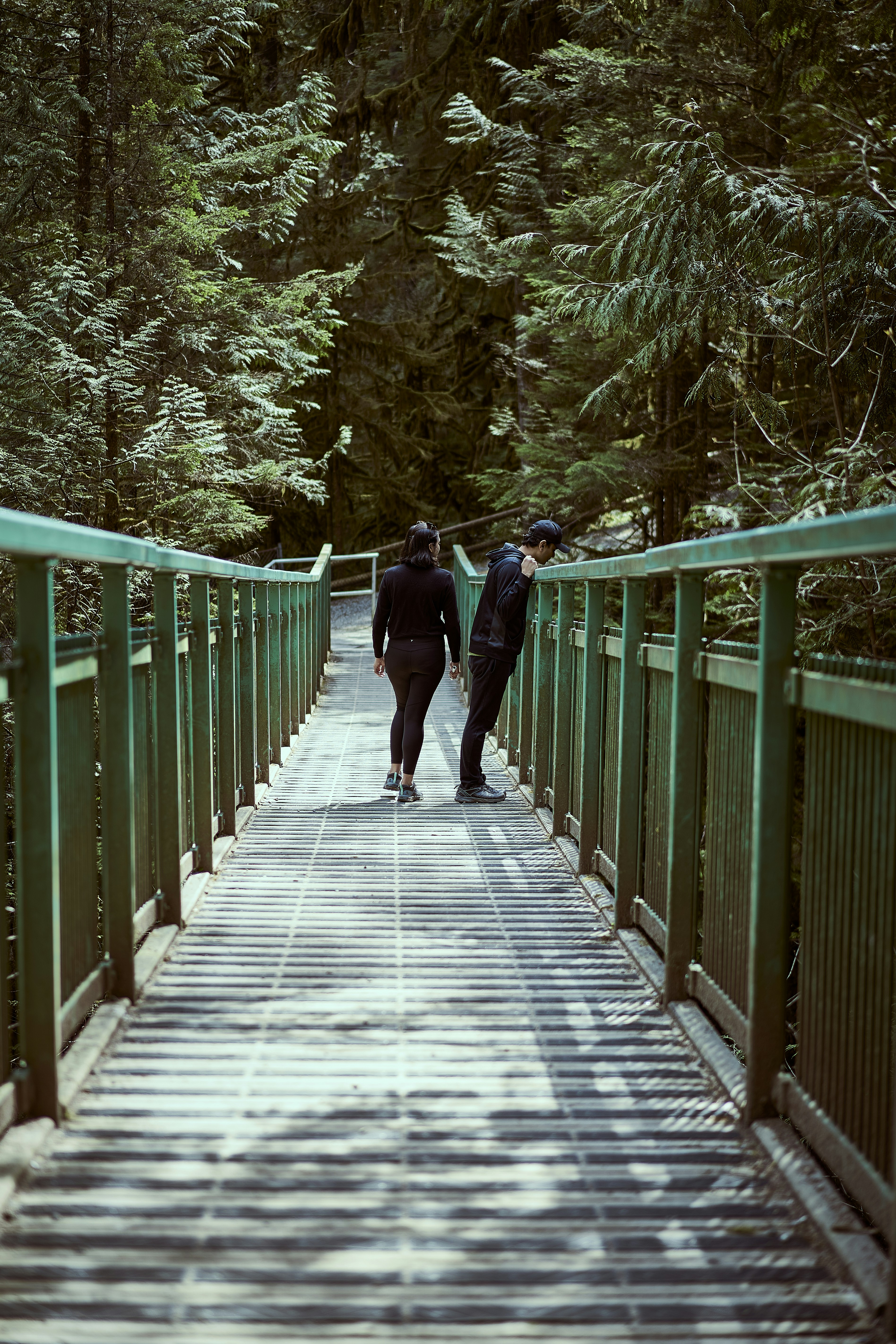 a couple of people walking on a bridge