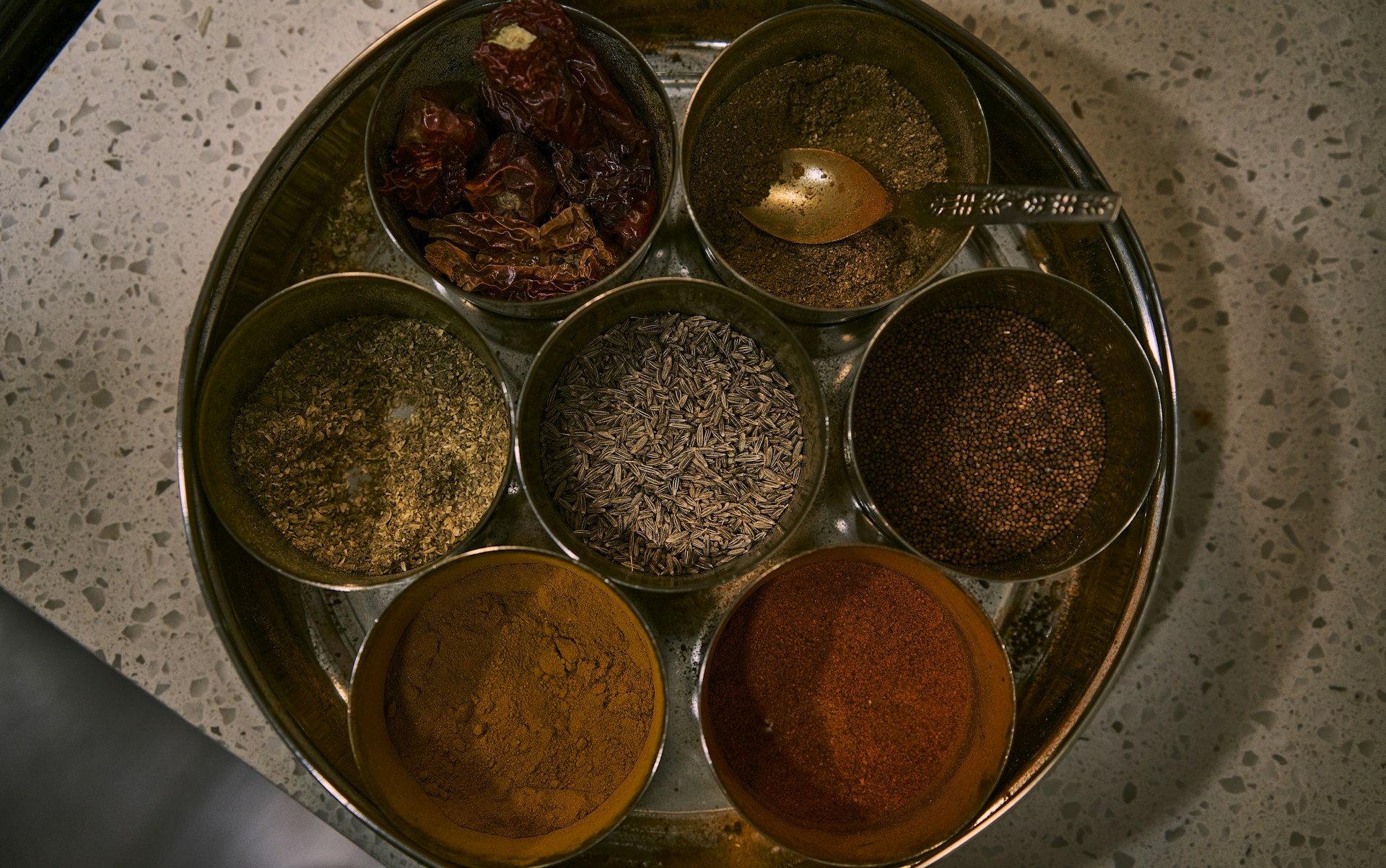 a group of small containers with brown liquid in them