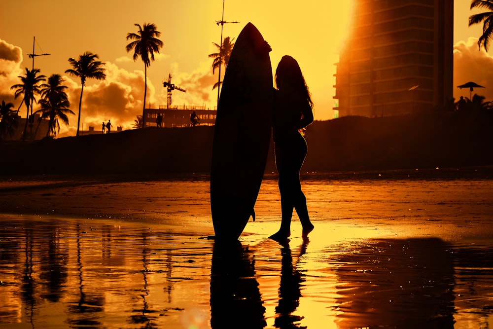 a man and woman kissing on a beach