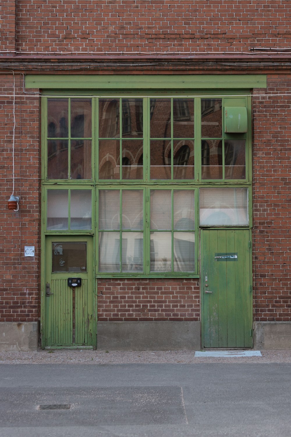 a green door on a brick building