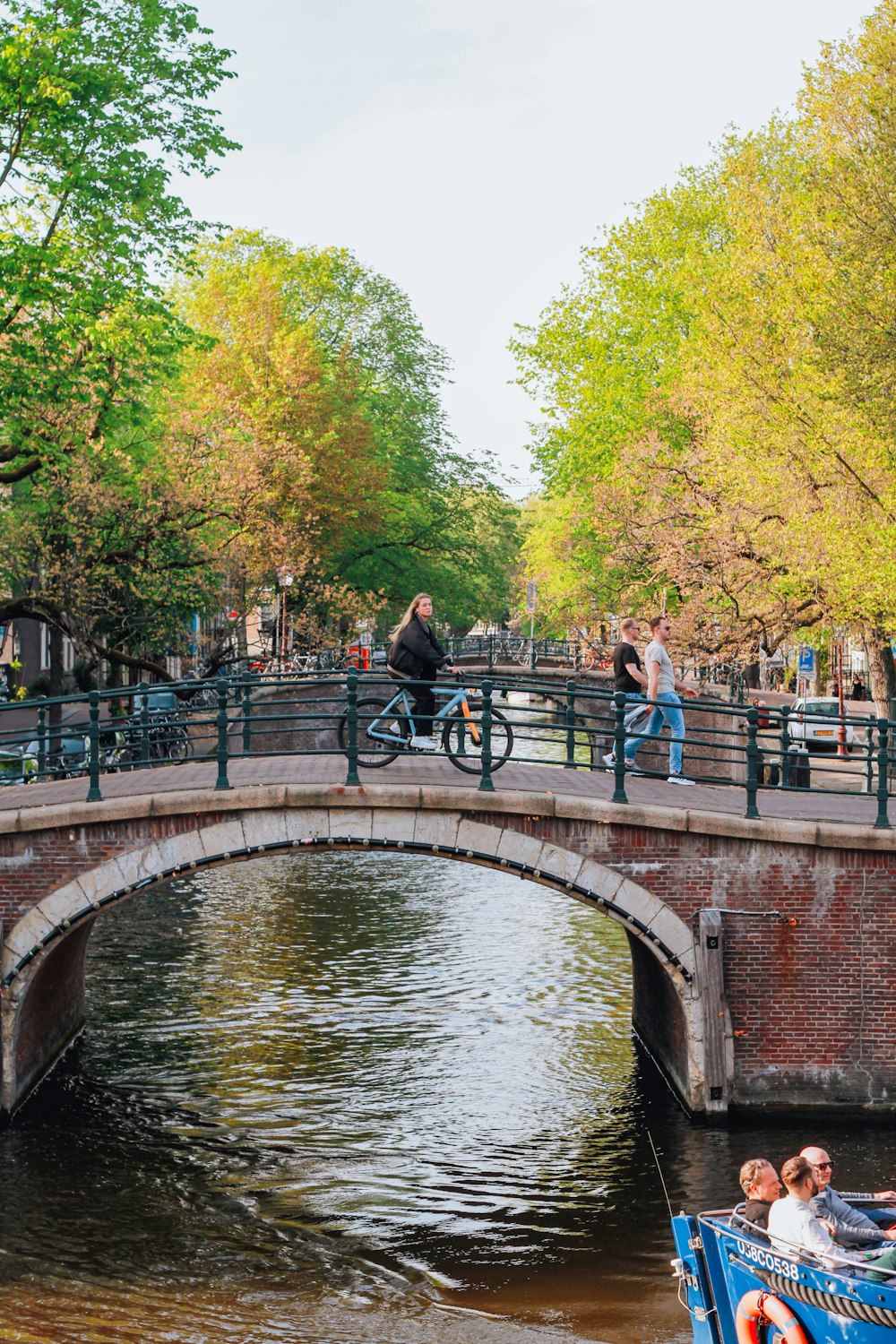 a group of people on a bridge over a river