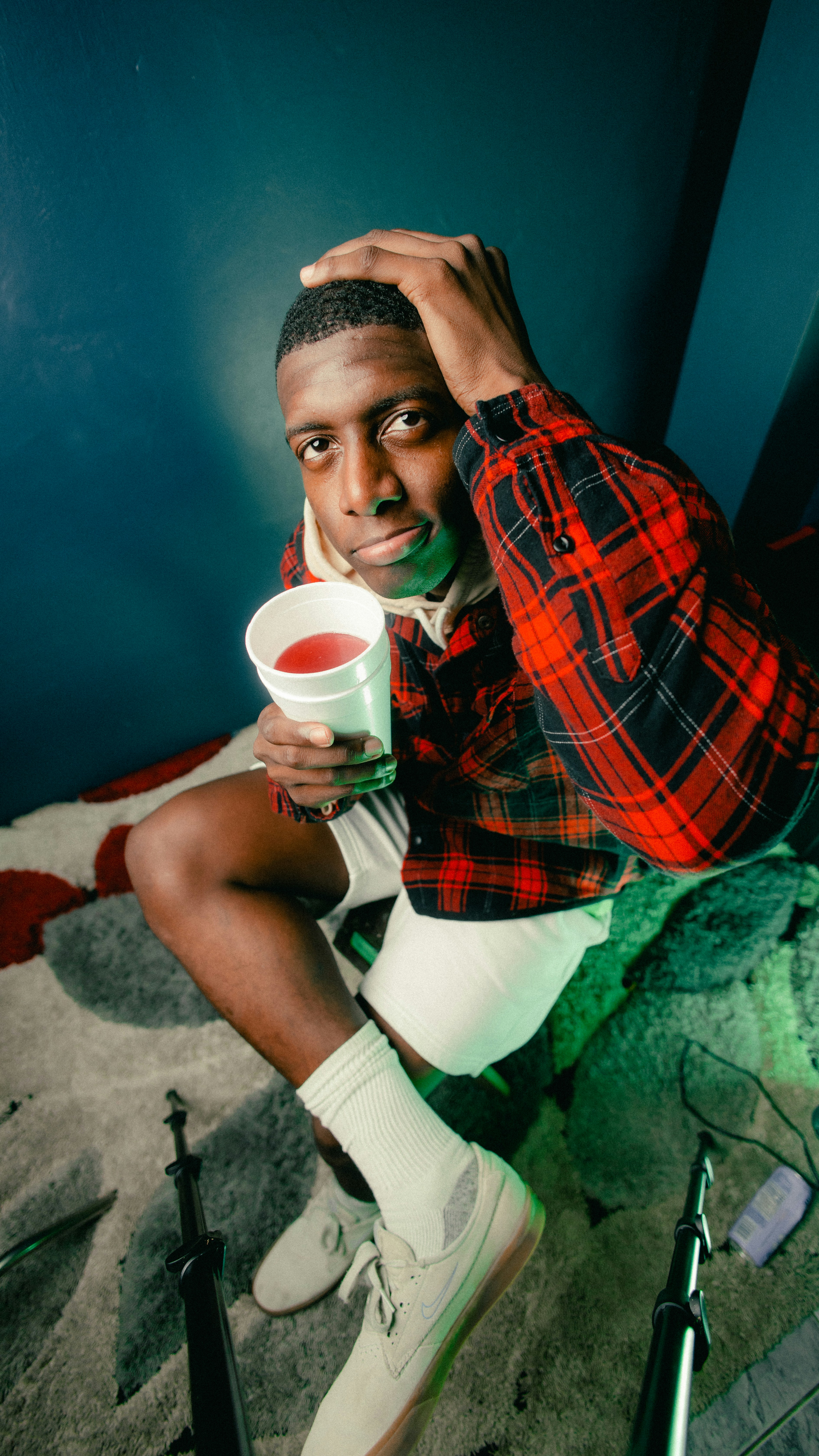 a person in a garment holding a cup