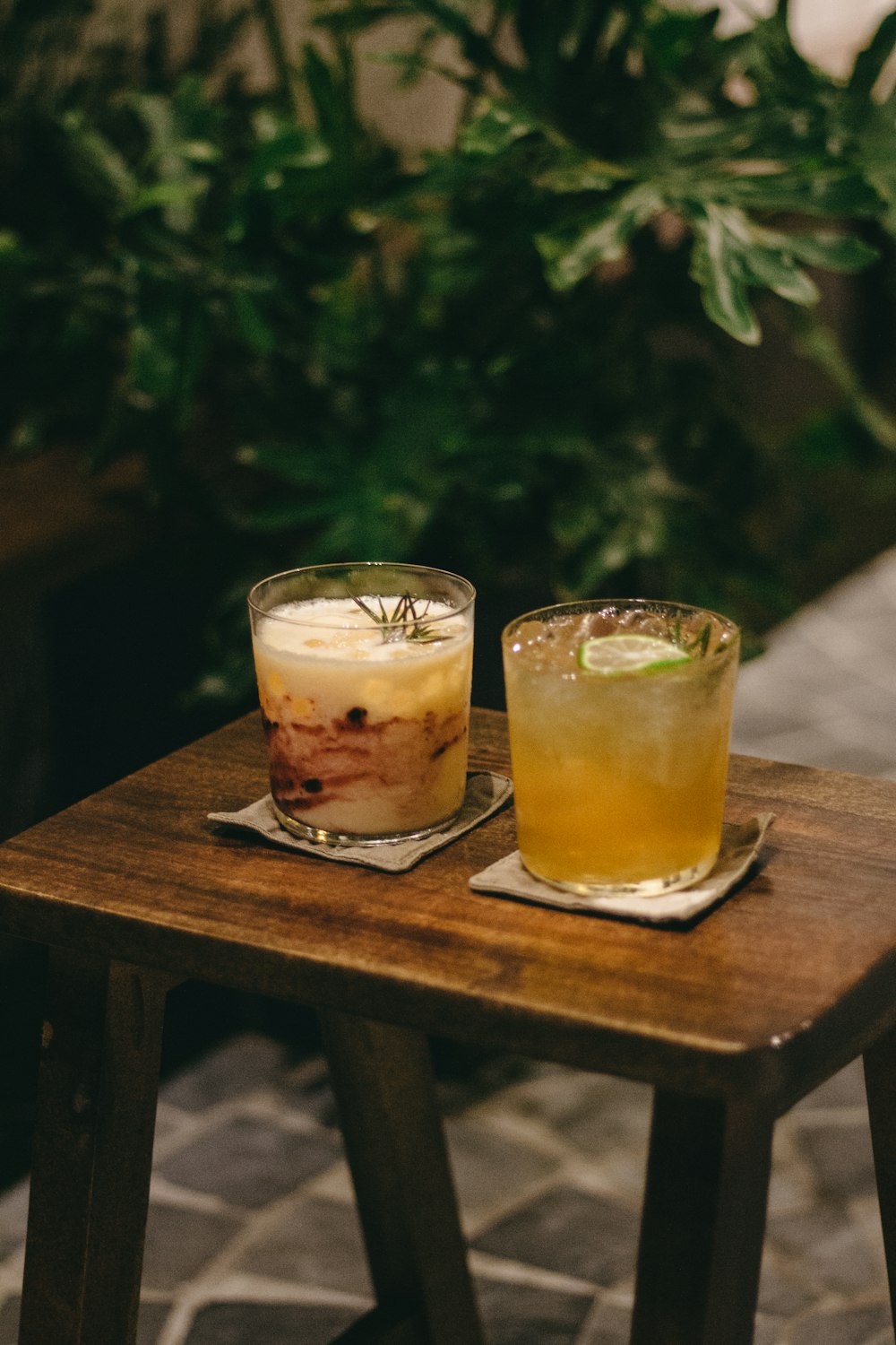 two glasses of liquid on a table