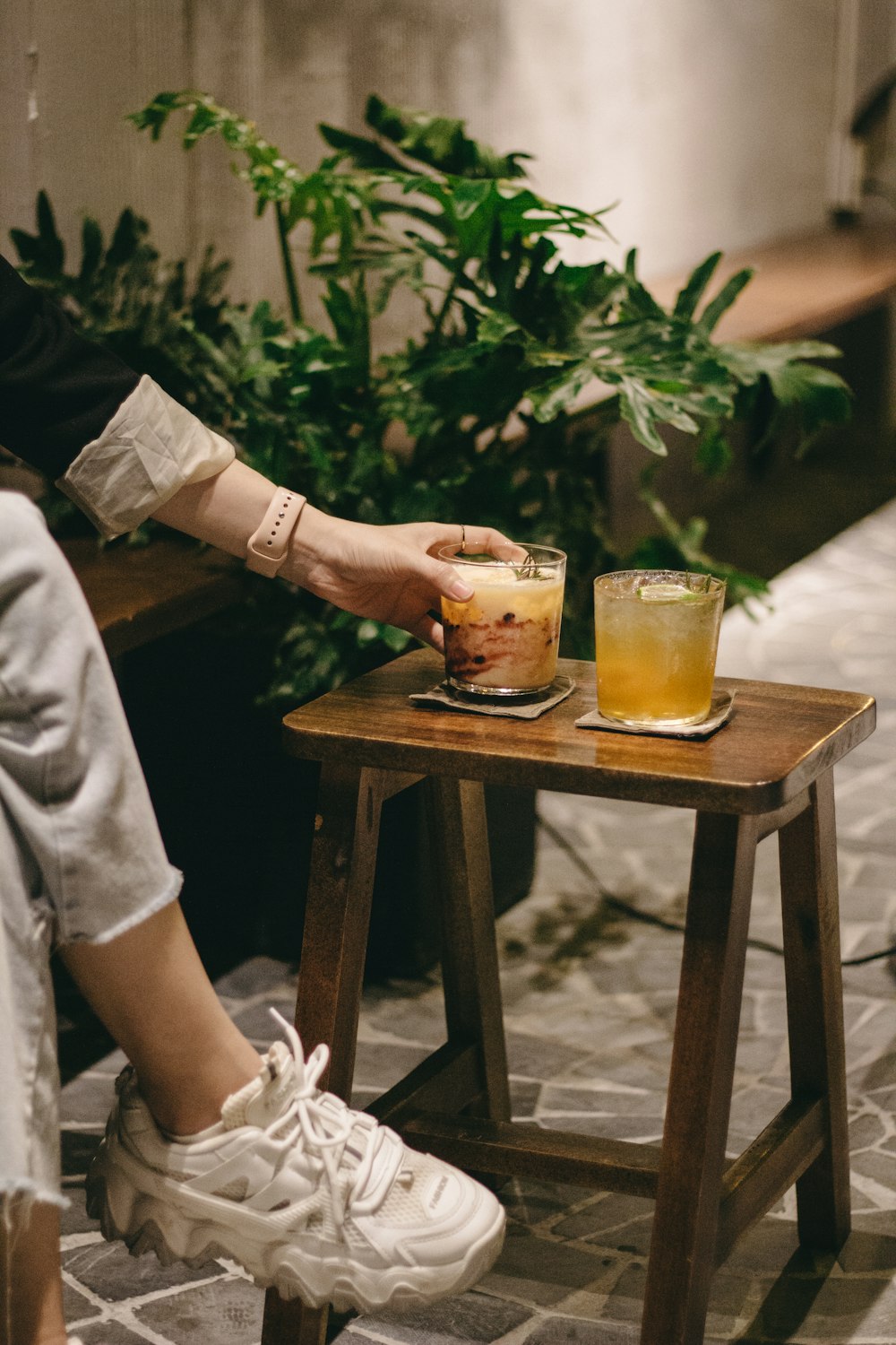 a person holding a glass of liquid