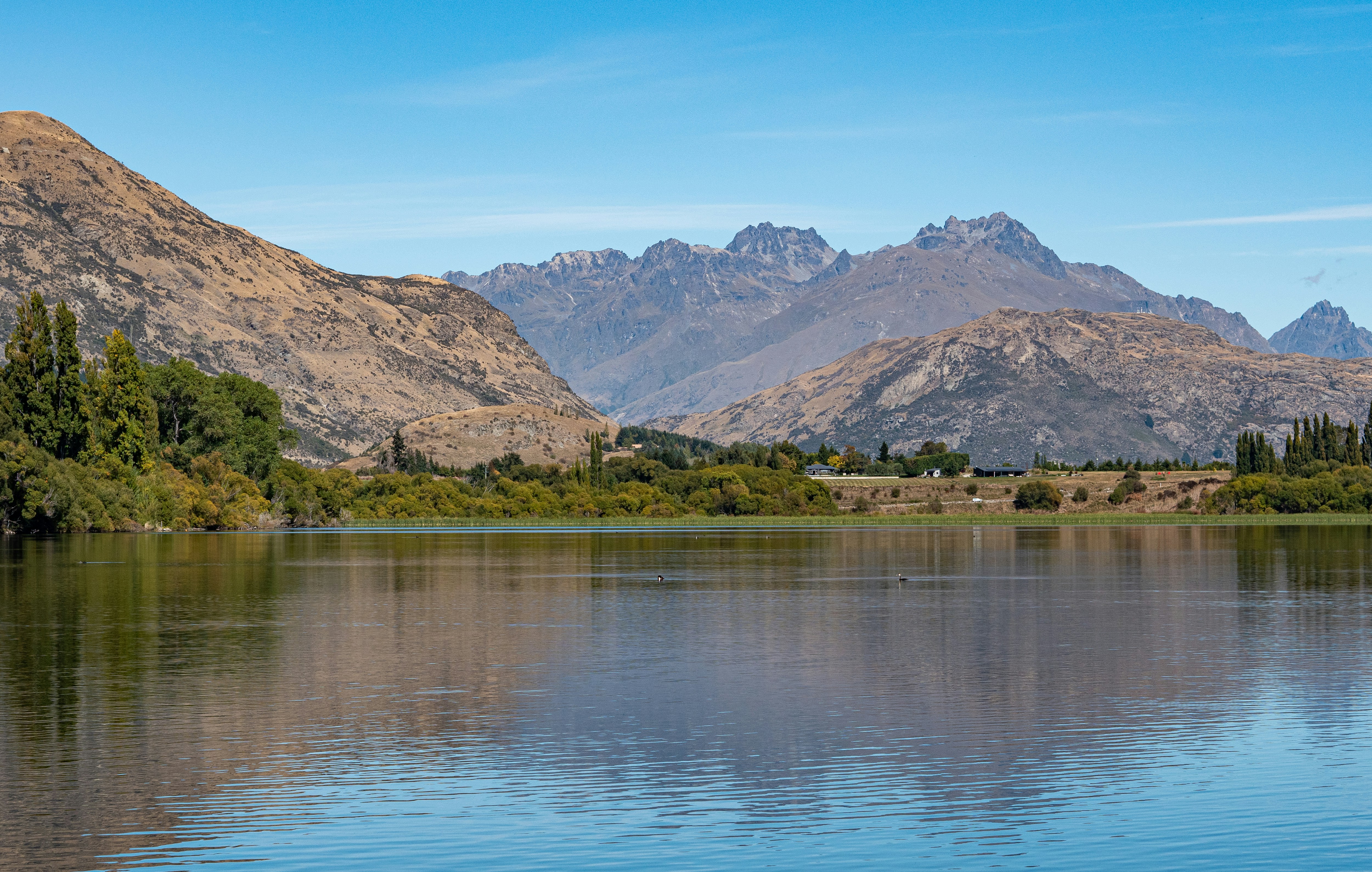 a body of water with mountains in the background