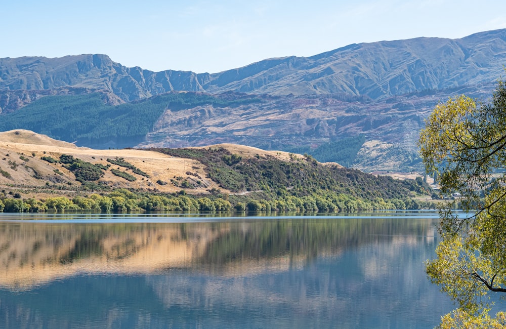 a lake with hills in the background