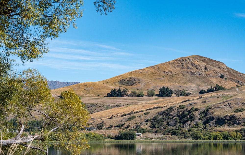 a body of water with hills in the back