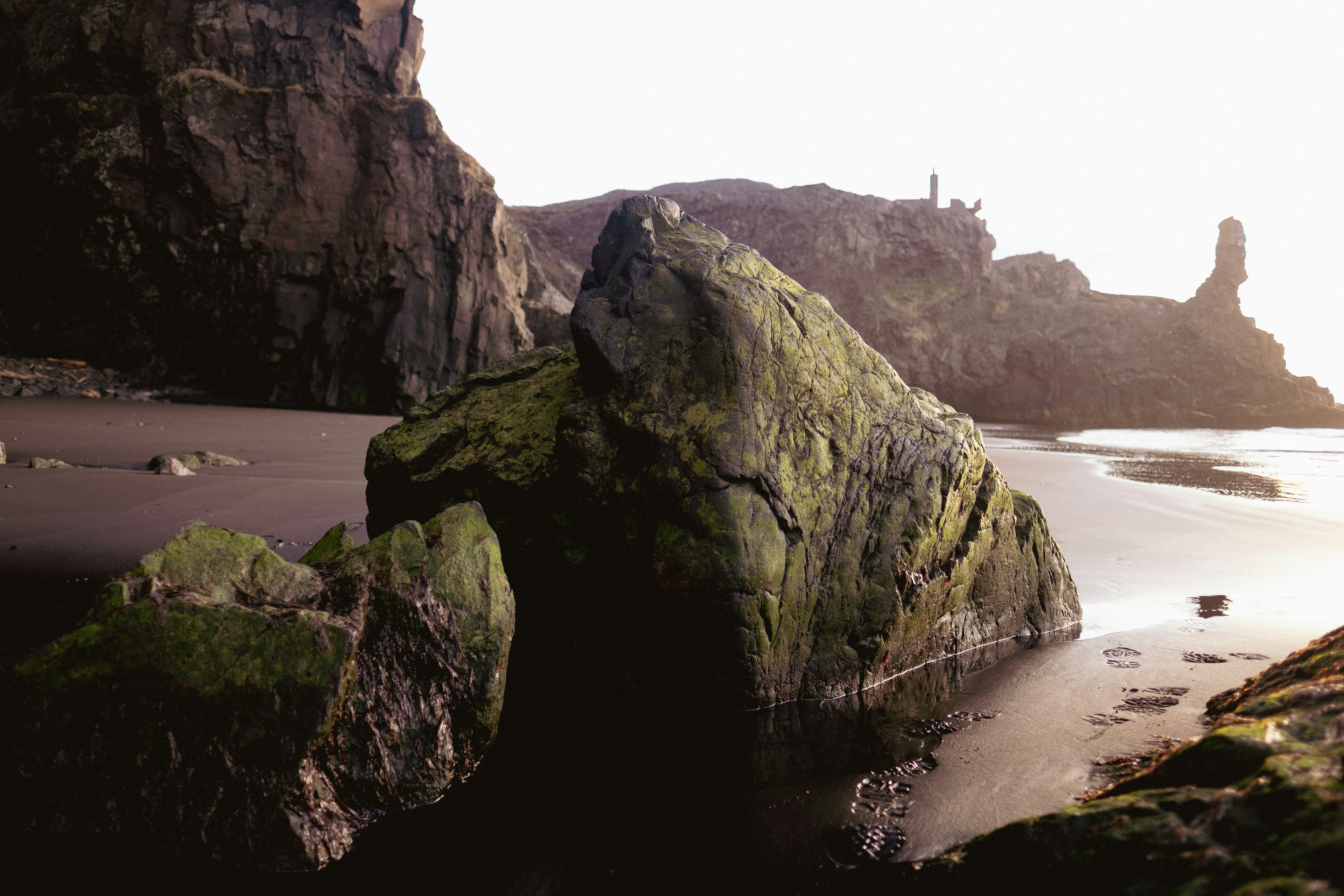a rocky beach with a lighthouse