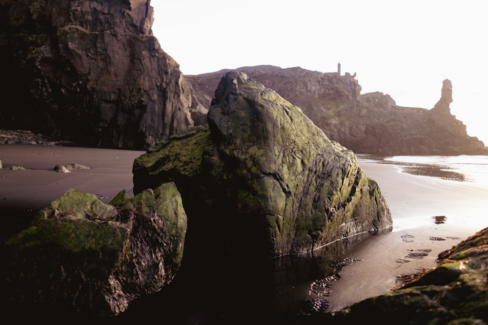 a rocky beach with a lighthouse