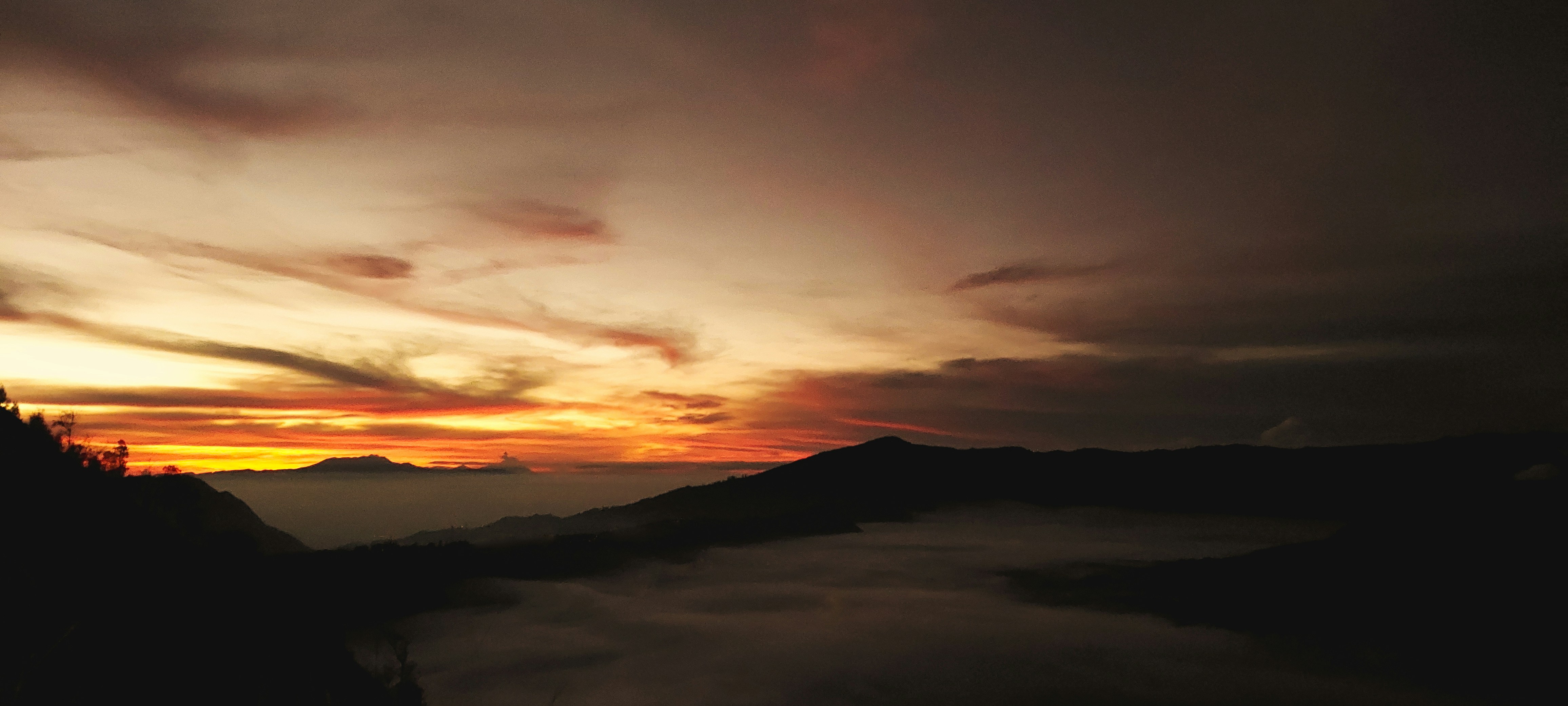 a sunset over a mountain range