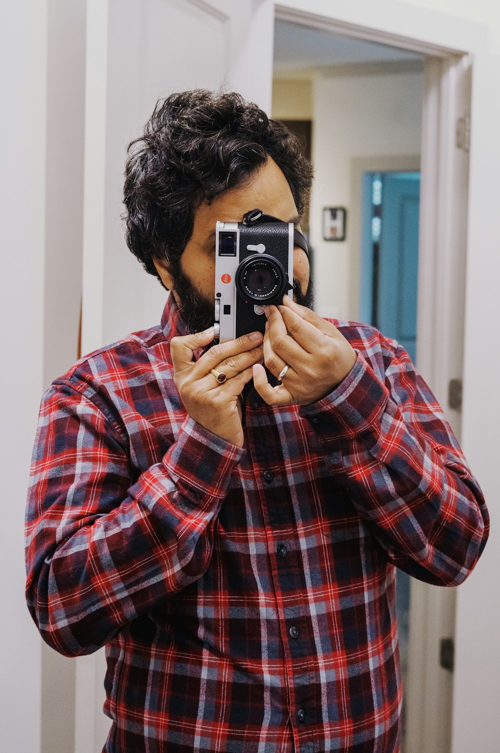 a man taking a picture of himself in the mirror