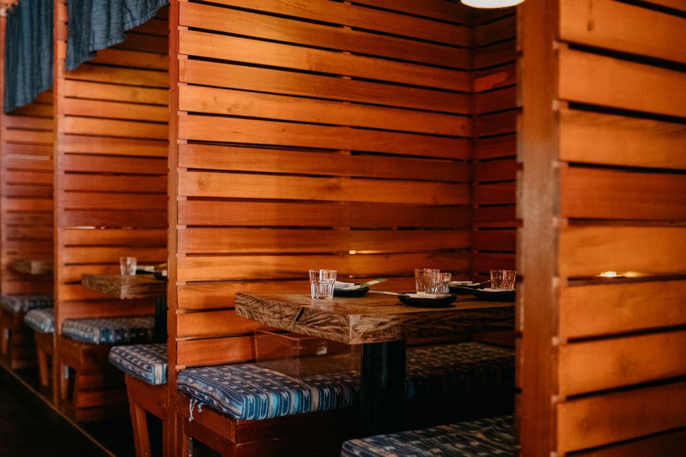 a wooden cabin with a table and chairs