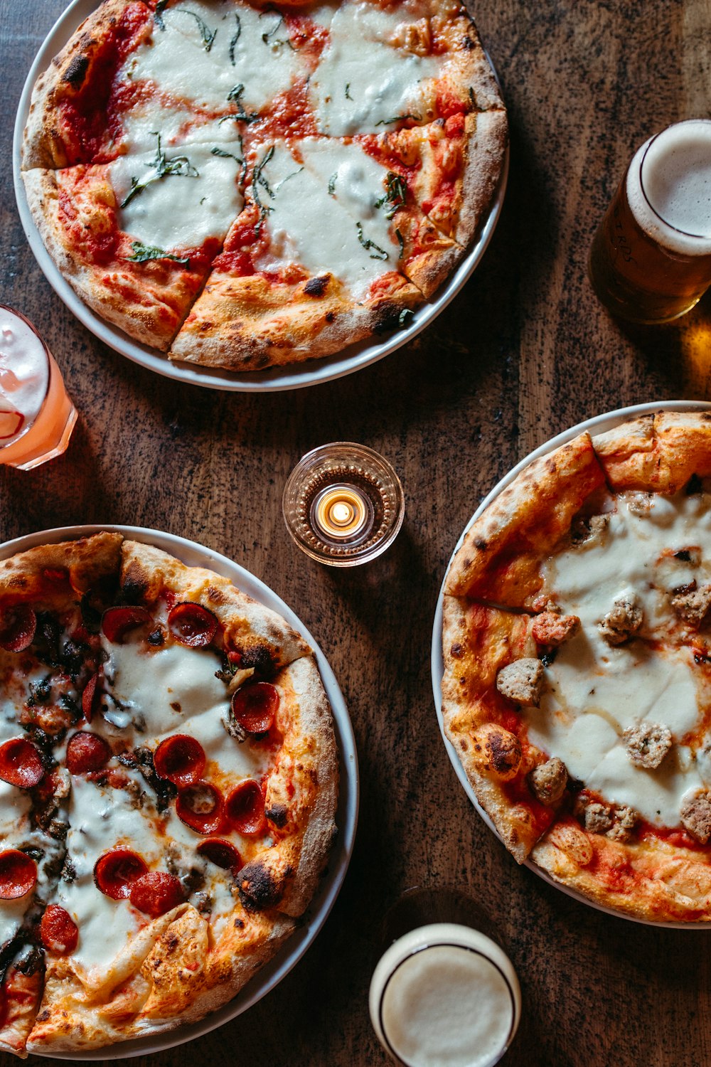 a couple of pizzas sit on a table