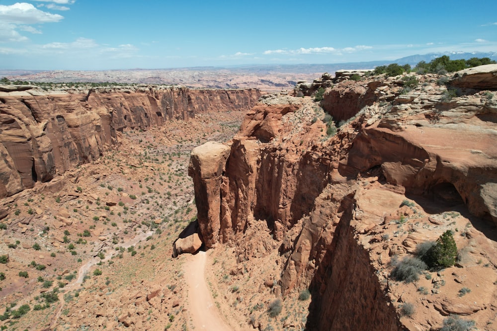 a rocky canyon with a dirt road