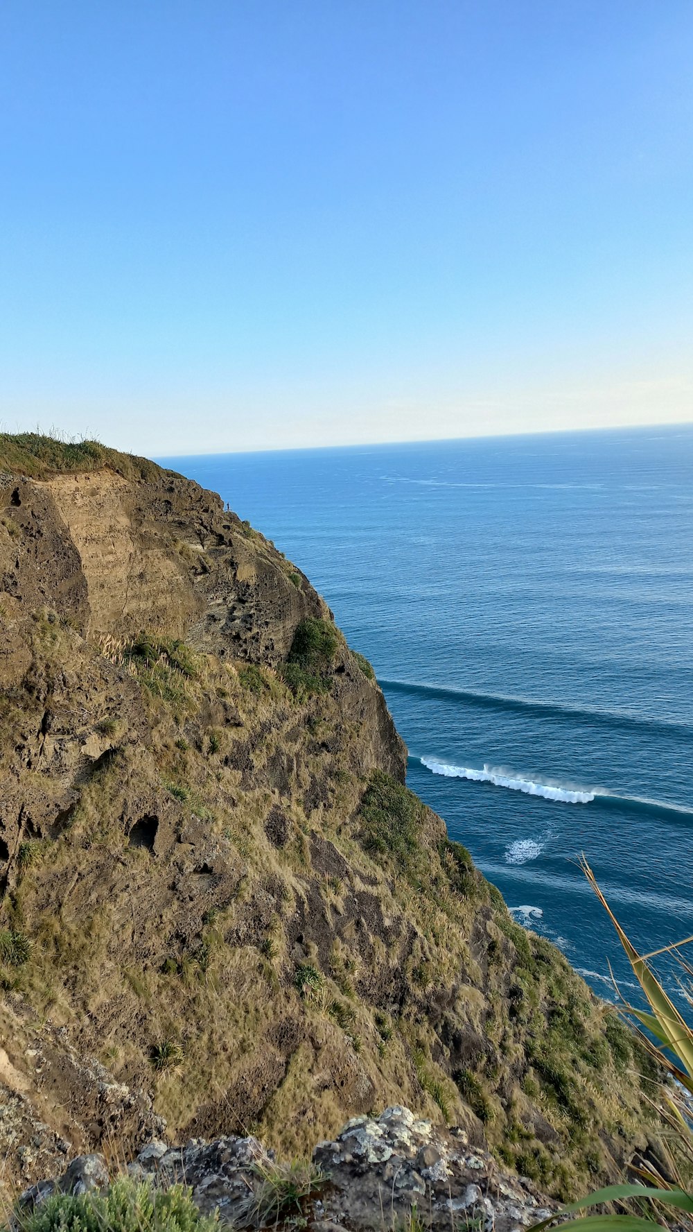 a cliff with a body of water below