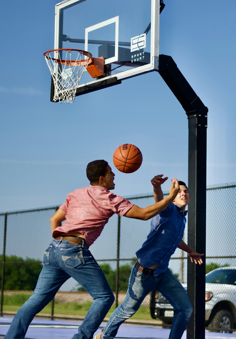 a couple of men playing basketball