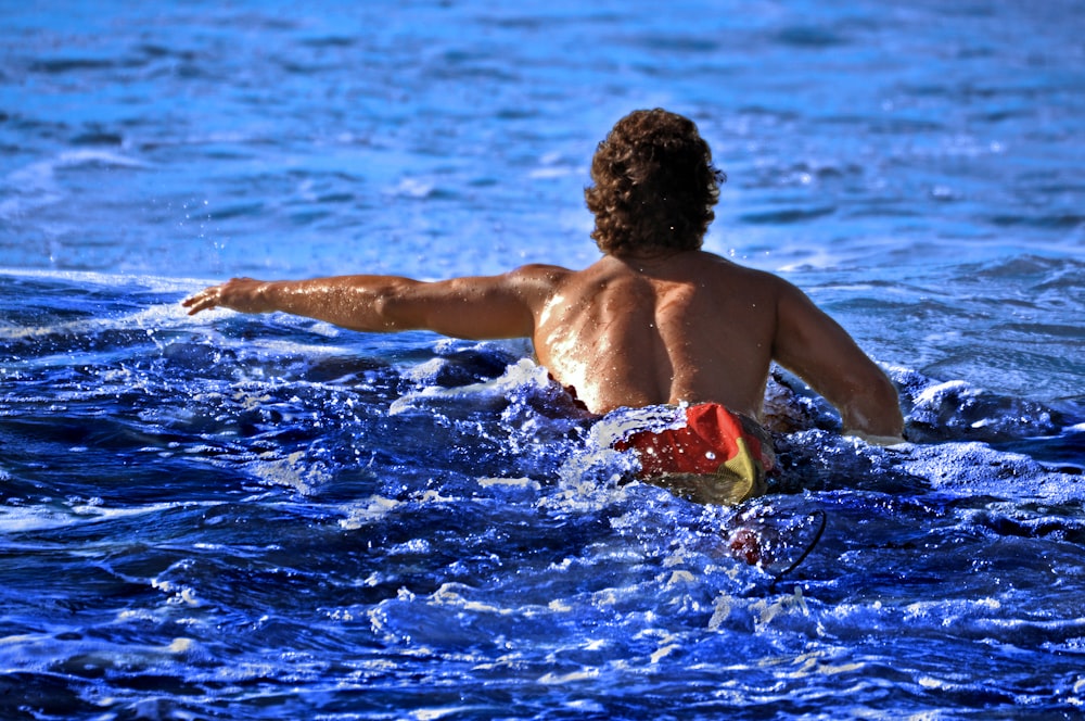 a man in the water with a frisbee