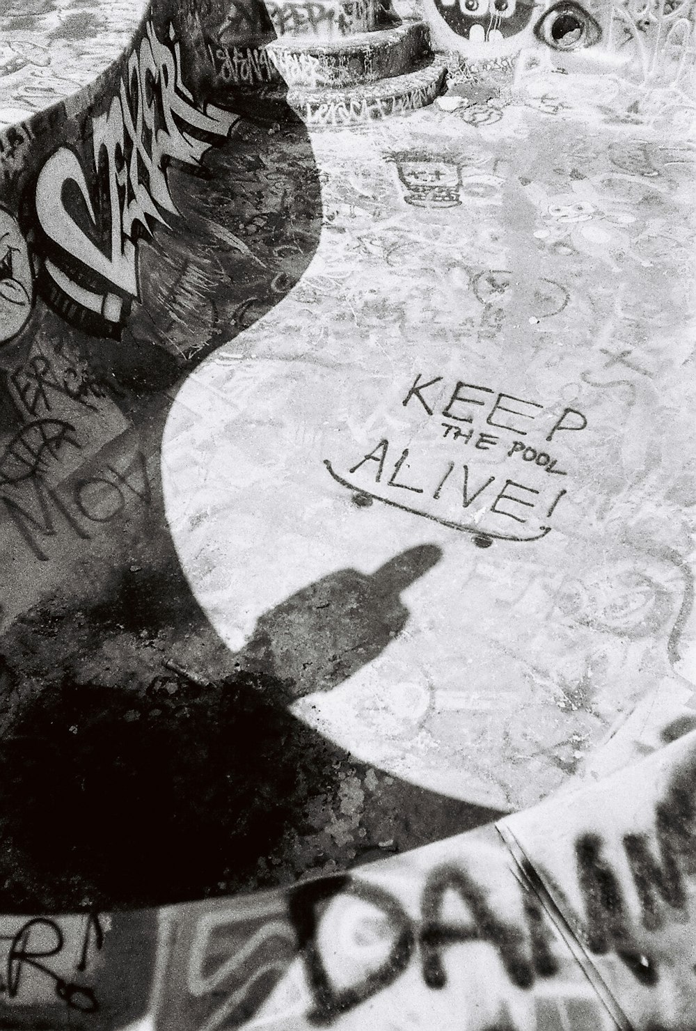 a black and white photo of a woman's face on a stone surface