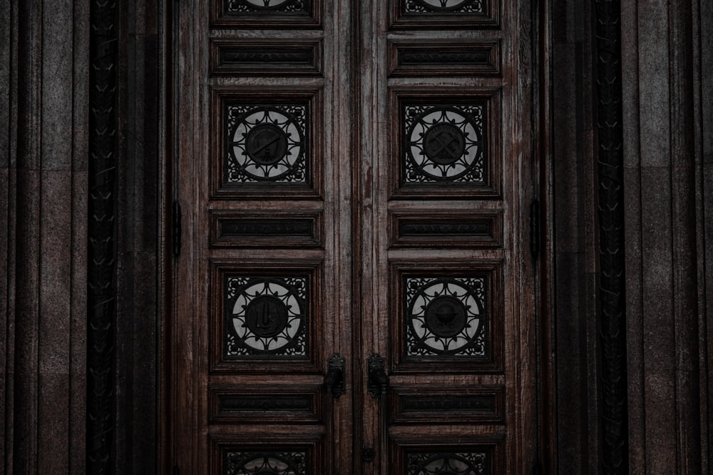 a group of clocks on a wooden door