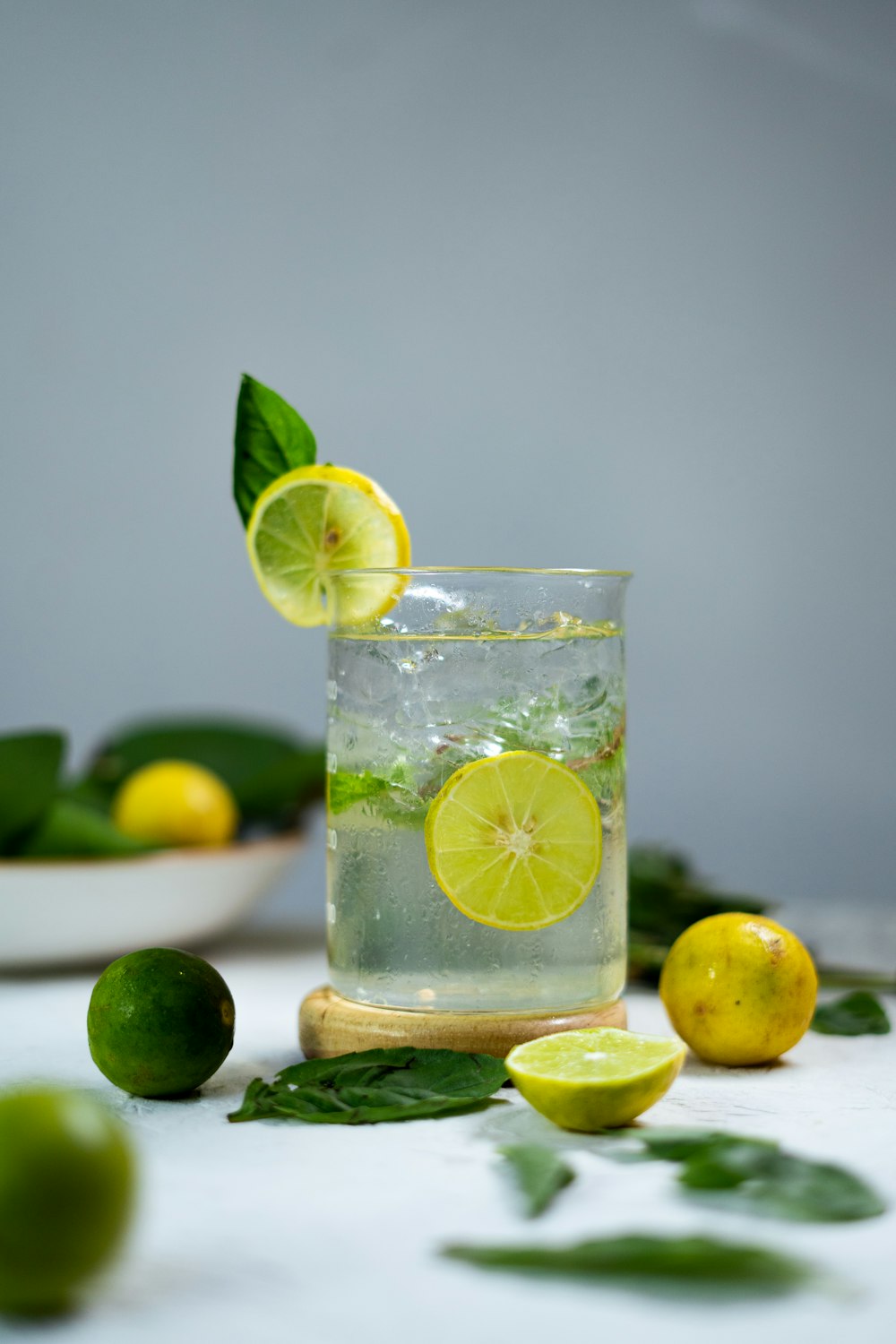 a glass of lemonade with limes and limes