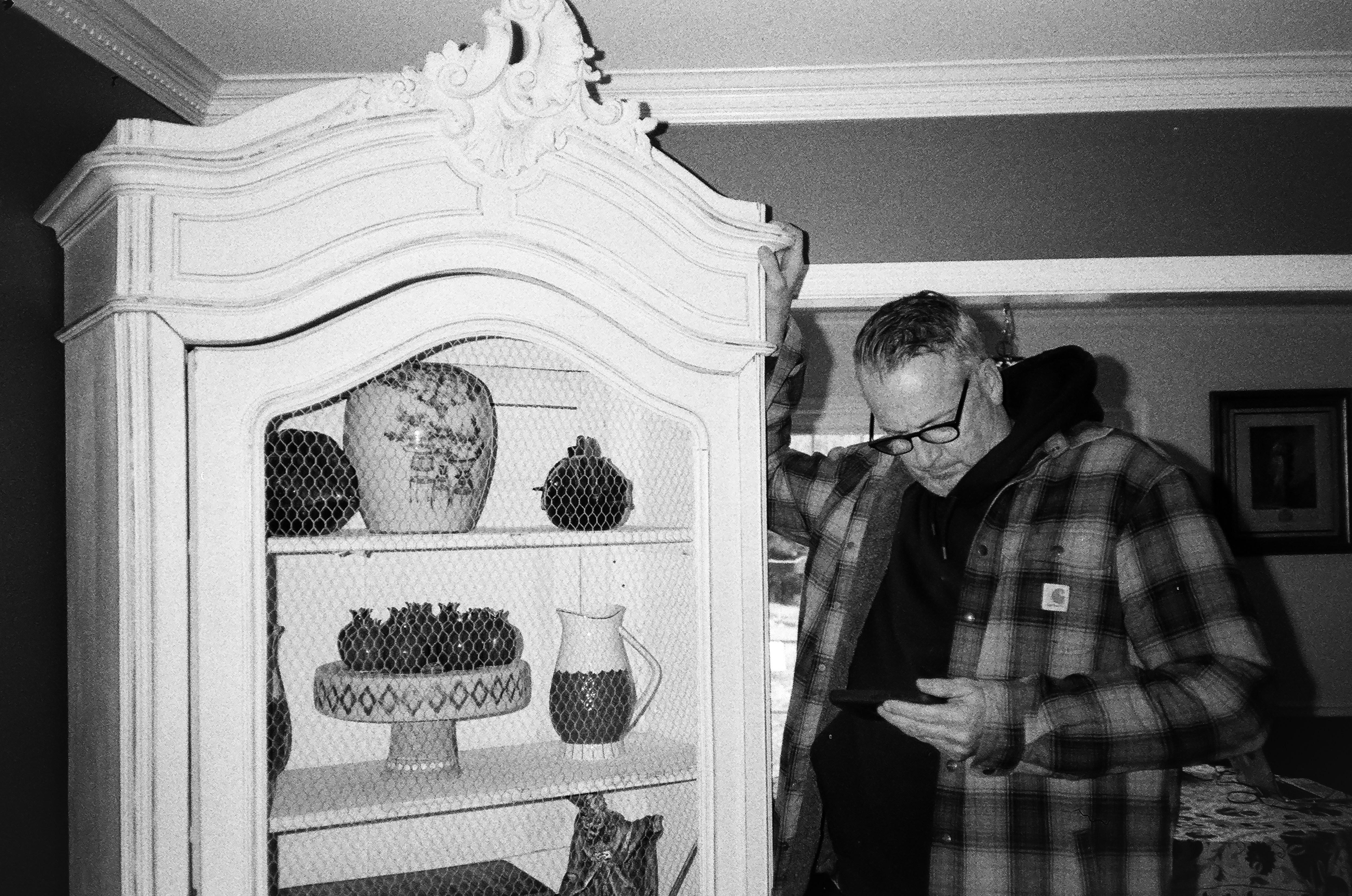 a couple of men looking at a display of pottery